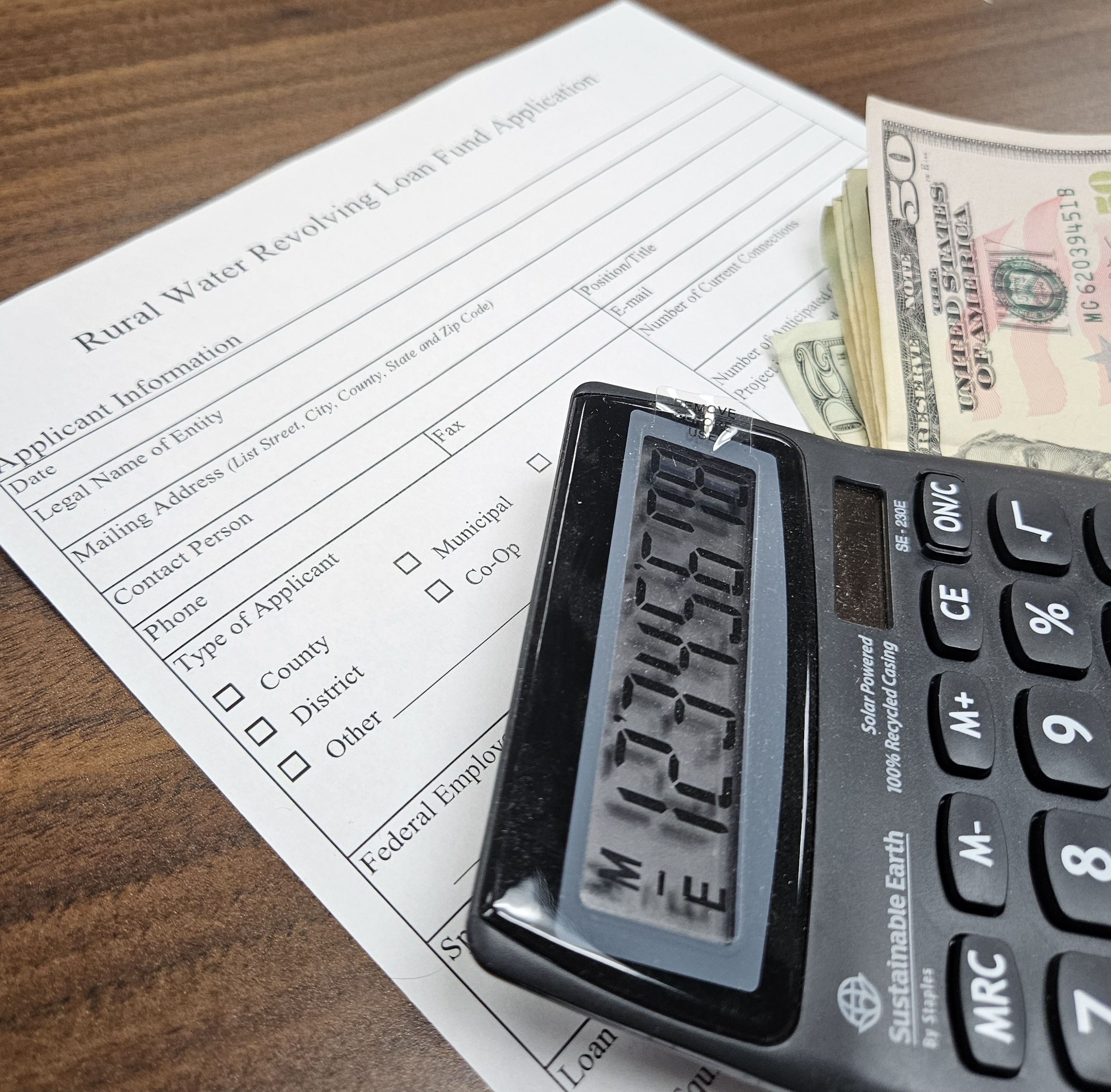 photo of loan app with money and calculator